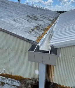 Commercial foam roof repair in progress with new foam and protective coating on a Florida flat roof