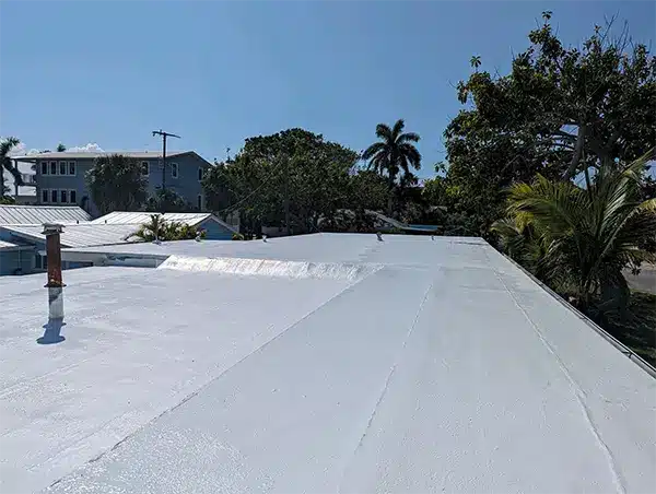 Expansive foam roof under sunlight, highlighting energy-efficient and durable roofing benefits compared to traditional methods.