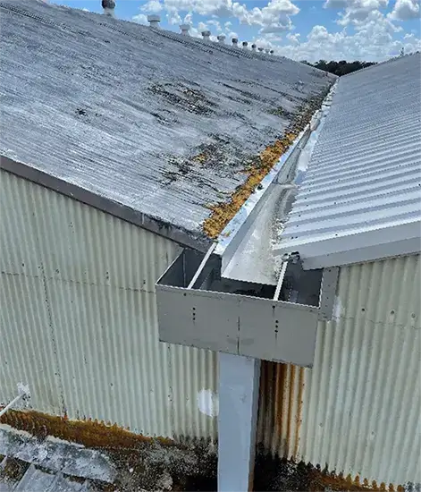 Close-up of a foam roof repair process with foam layer replacements and protective coating application.