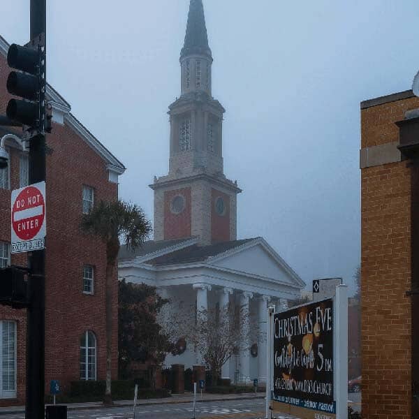 A foggy morning view of a church with a durable roof, emphasising the need for winter-proofing.