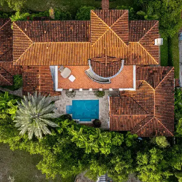 Aerial view of a luxurious villa with intricate tile roofing, symbolizing how classy it is to have an energy-efficient roof.