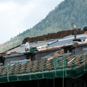workers repairing a commercial metal roof, ensuring proper installation and durability with high-quality materials and professional techniques.
