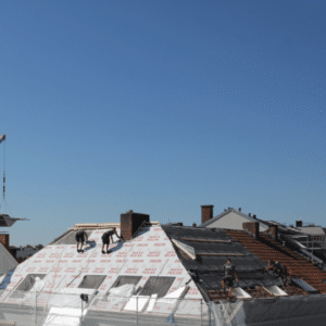 workers repairing a commercial metal roof, installing waterproof underlayment and securing new roofing materials to ensure long-term durability.