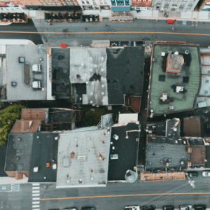 an aerial view of multiple commercial rooftops in varying conditions, emphasizing the importance of professional roof inspections to identify damage, ensure proper maintenance, and extend roof lifespan.