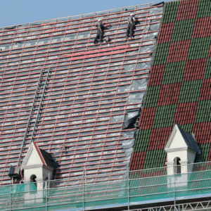 A roofer replacing damaged shingles on a commercial building, weighing the options between repair and replacement.