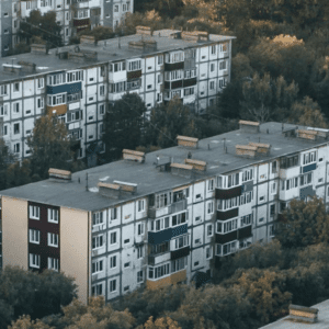 rows of apartment buildings with flat roofs, showing how minimal slope is designed to improve water drainage