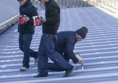 Book a free roof inspection with men repairing roof