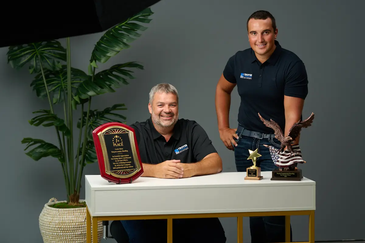 Lester Troyer and the Troyer Commercial Roofing team with industry awards, representing the credibility and transparency you should expect when hiring a roofer in Florida.