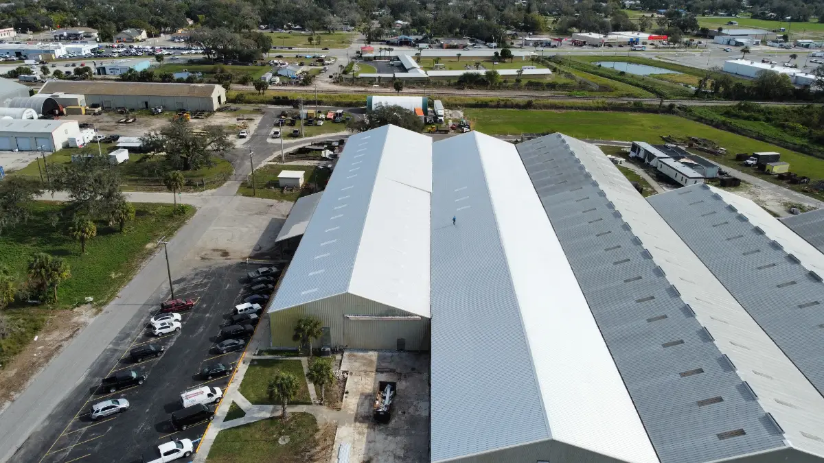 Aerial view of a large Florida warehouse roof that’s been worked on by a legitimate roofer