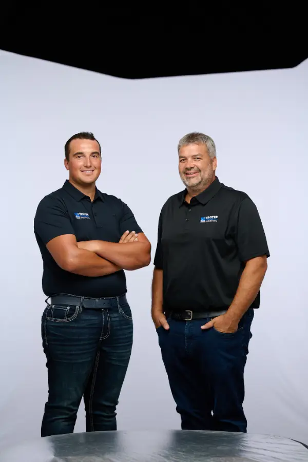 Lester Troyer of Troyer Commercial Roofing displaying certifications and industry awards, demonstrating the importance of verifying contractor licenses.