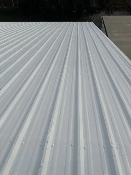 Smooth white commercial metal roof after Conklin MR System restoration in Sarasota