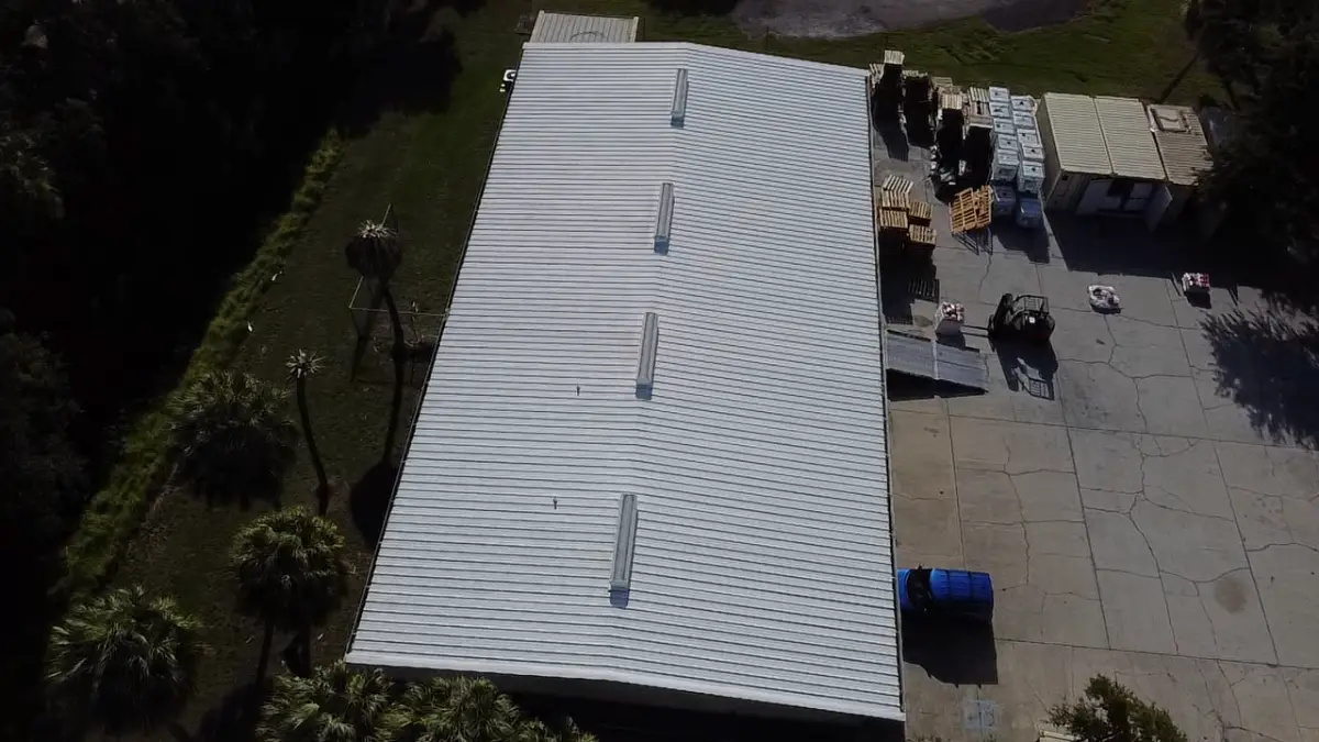 Completed metal roof restoration with white reflective coating in Sarasota Florida