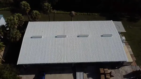 Completed metal roof restoration with white reflective coating in Sarasota Florida