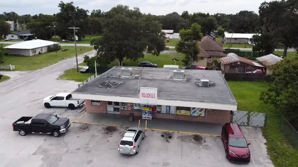 Aerial view of a Florida commercial retail building with a modified bitumen flat roof system