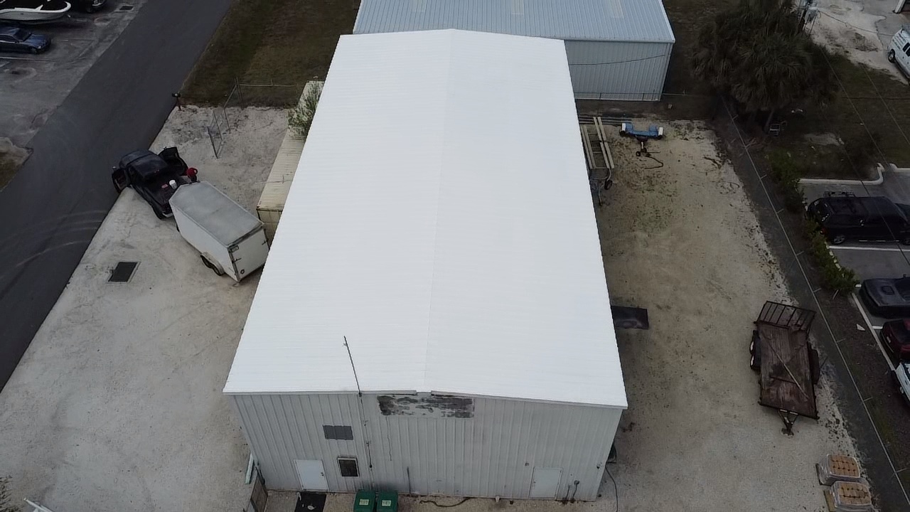Aerial view of an industrial building after a spray polyurethane foam roof with white top coat