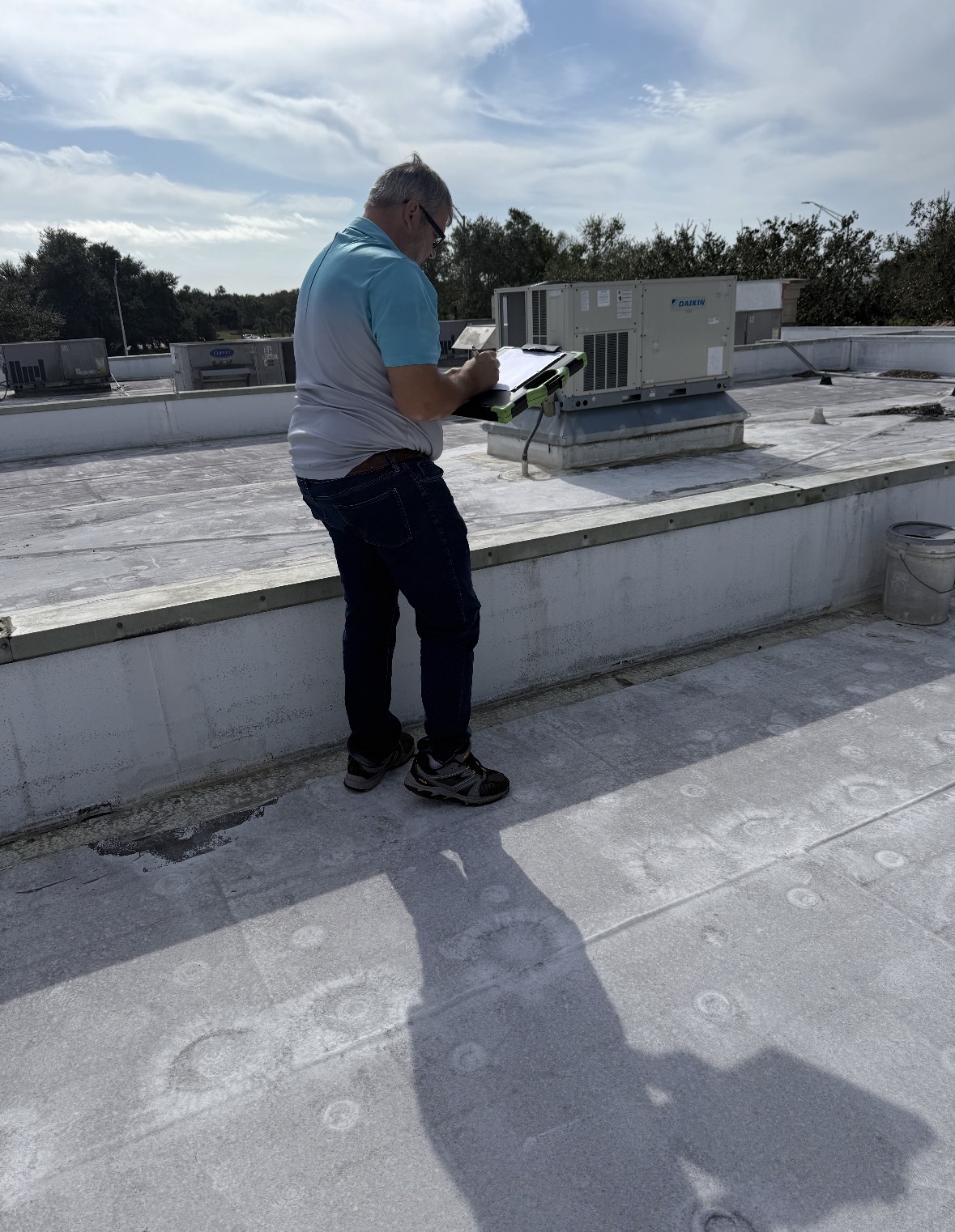 Lester Troyer inspecting a commercial roof