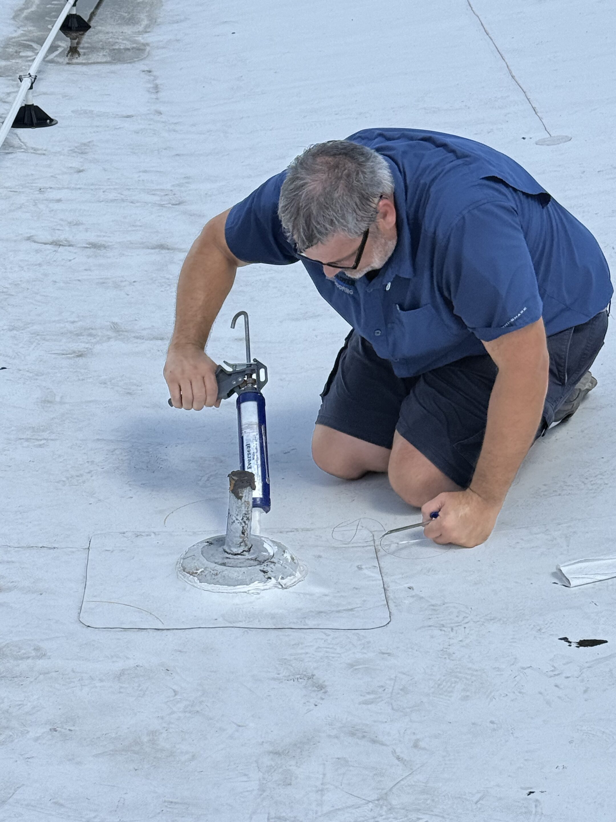 Lester Troyer repairing a commercial roof leak