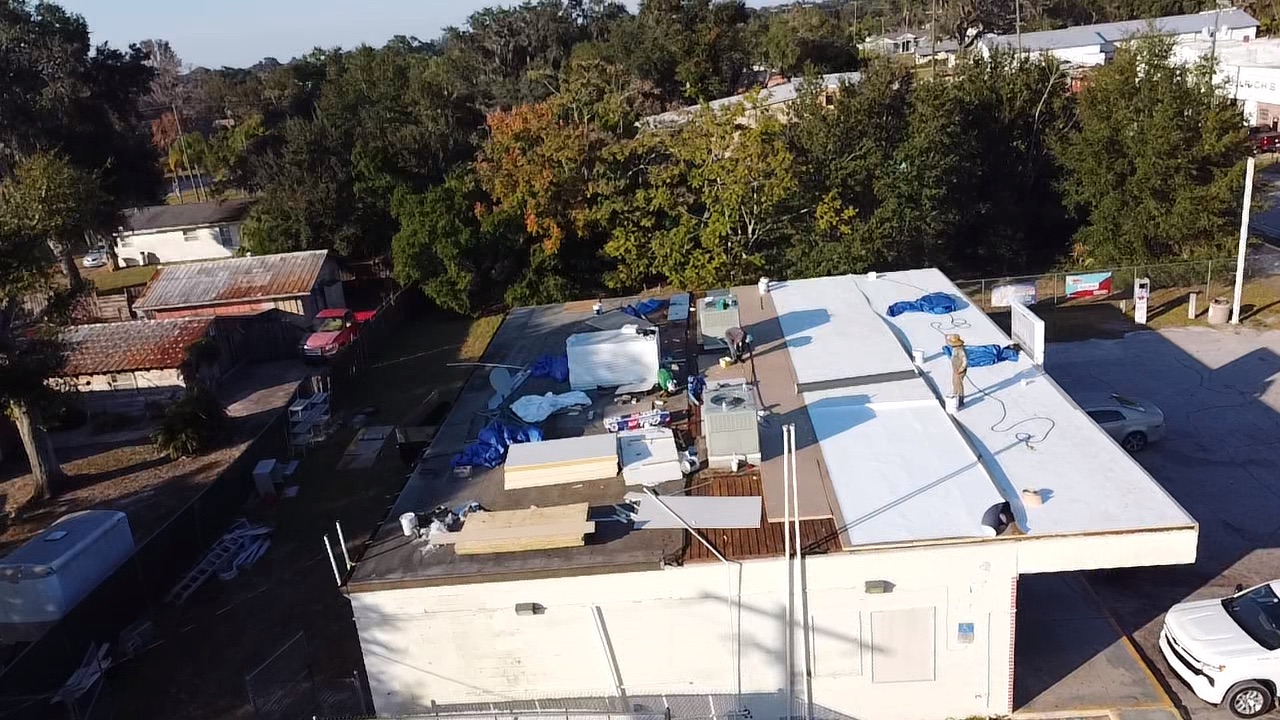 Old roof being torn off a commercial building before TPO replacement