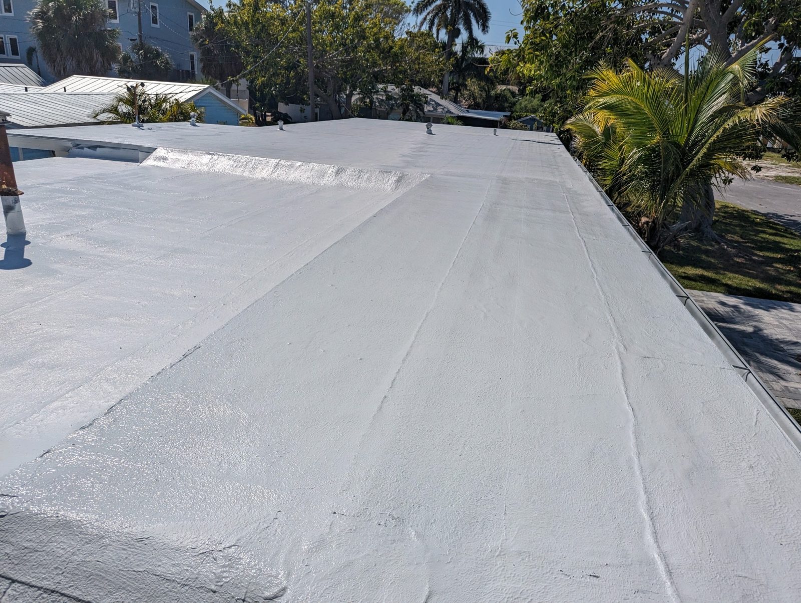 Commercial flat roof in Bradenton after spray polyurethane foam restoration and white top coat